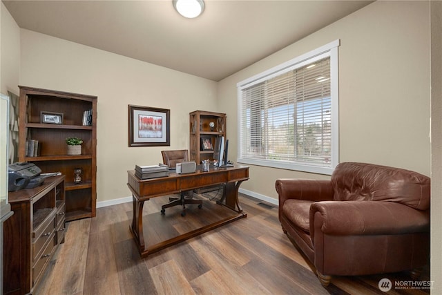 office space with visible vents, baseboards, and dark wood finished floors