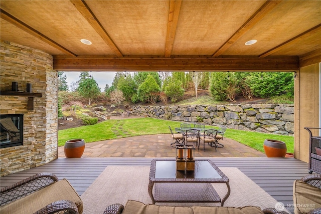 view of patio with outdoor dining area and an outdoor stone fireplace