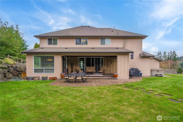 rear view of property with a patio and a lawn