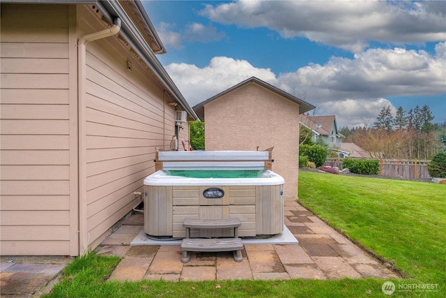 view of patio / terrace featuring fence and a hot tub