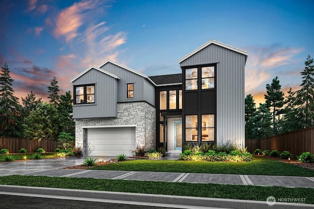 view of front of home with an attached garage, fence, stone siding, and driveway