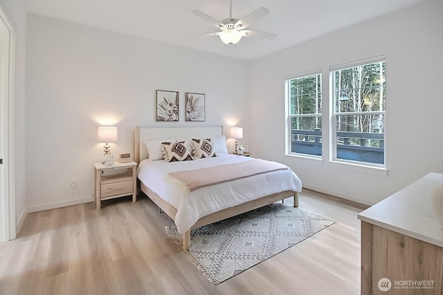bedroom with light wood finished floors, baseboards, and a ceiling fan