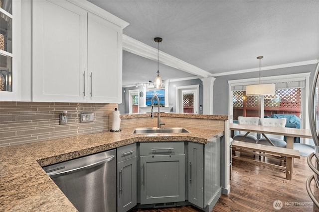 kitchen featuring stainless steel dishwasher, gray cabinetry, plenty of natural light, and a sink