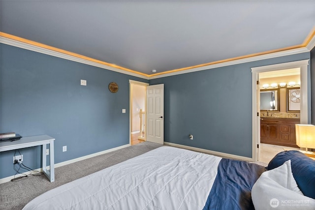 carpeted bedroom with baseboards, ensuite bath, and ornamental molding