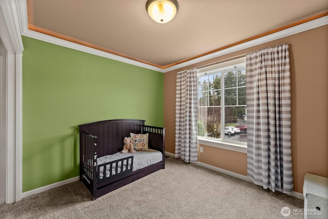 bedroom featuring a nursery area, carpet, baseboards, and ornamental molding