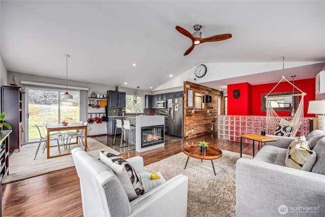 living room featuring recessed lighting, dark wood-type flooring, a ceiling fan, and vaulted ceiling