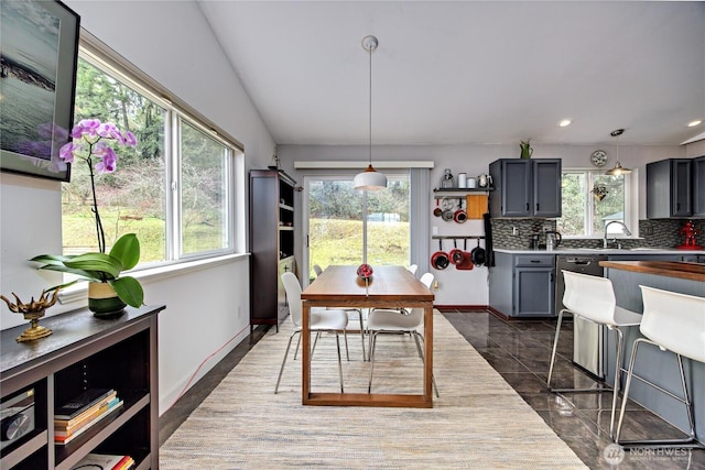 dining space with a wealth of natural light, recessed lighting, and baseboards