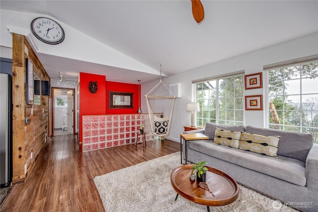 living room with wood finished floors and vaulted ceiling