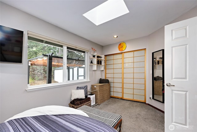 carpeted bedroom with recessed lighting and a skylight