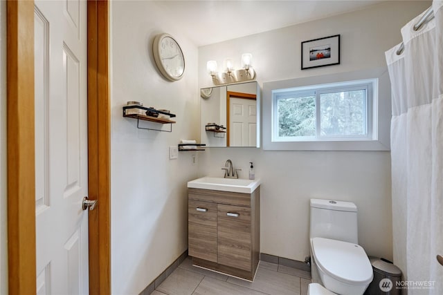 full bathroom featuring tile patterned floors, baseboards, toilet, and vanity