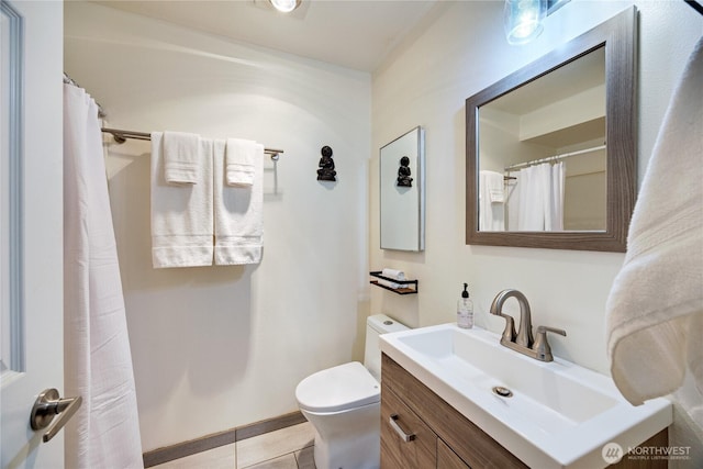 full bathroom with tile patterned flooring, a shower with curtain, toilet, and vanity