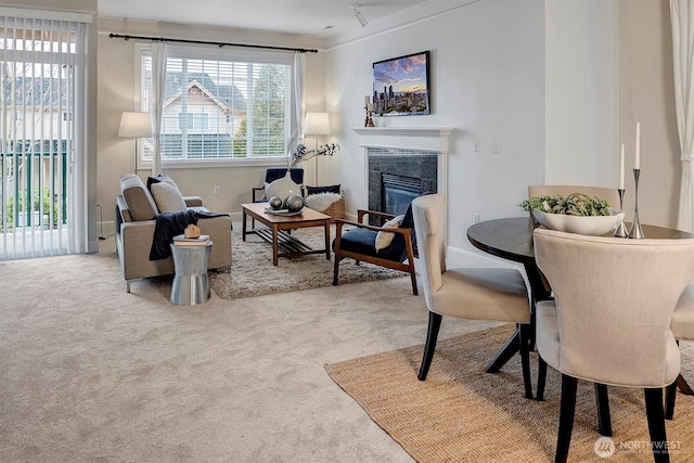 carpeted living room with a premium fireplace