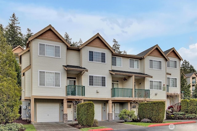 multi unit property featuring an attached garage and driveway