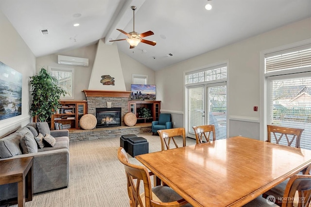 dining space with visible vents, plenty of natural light, beam ceiling, and a fireplace