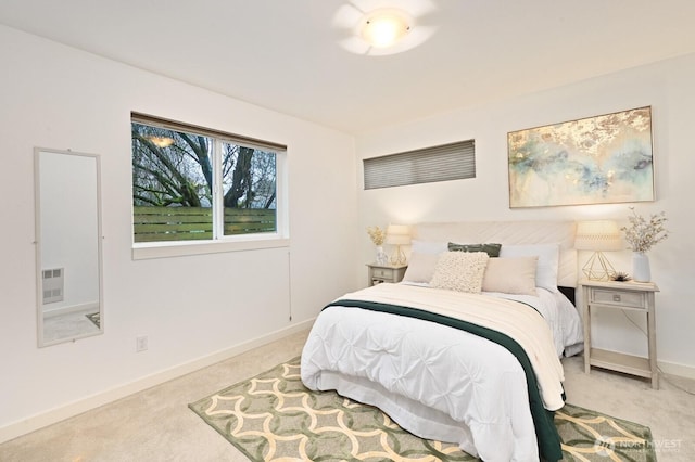 carpeted bedroom featuring baseboards