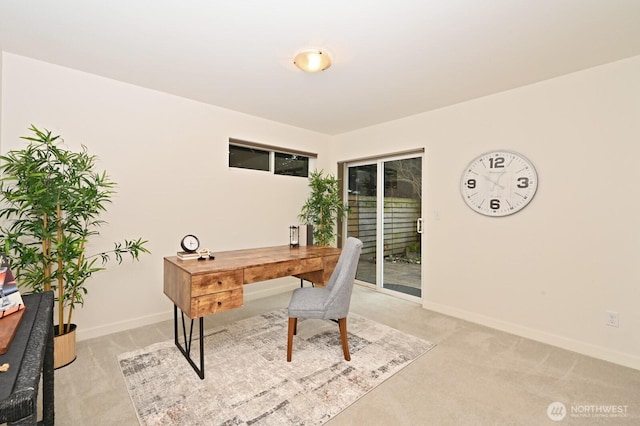 home office with baseboards and light carpet