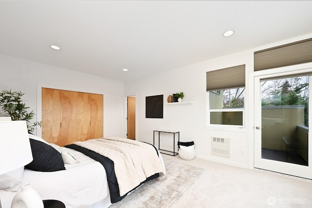 carpeted bedroom featuring a closet and recessed lighting