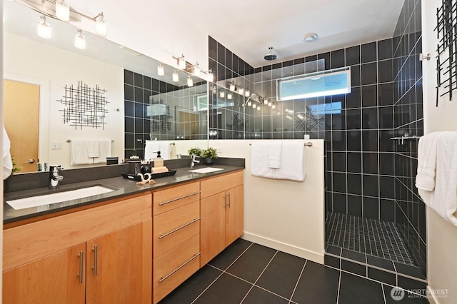 bathroom with tile patterned floors, a walk in shower, double vanity, and a sink