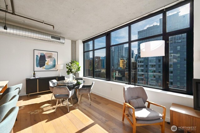 interior space featuring visible vents, baseboards, and hardwood / wood-style flooring