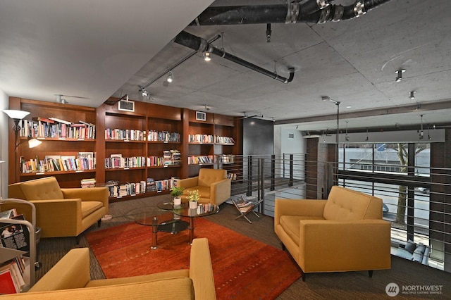 sitting room with built in features, visible vents, and track lighting