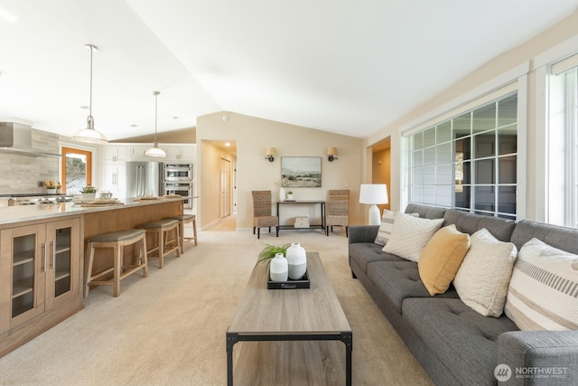 living room featuring lofted ceiling and light carpet