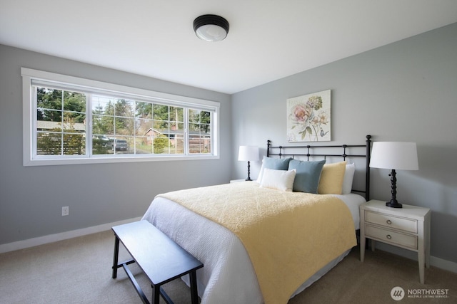 carpeted bedroom featuring baseboards