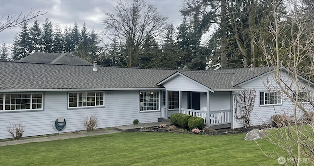 single story home with a porch, a front lawn, and a shingled roof