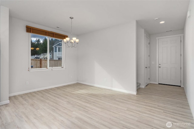 unfurnished dining area with recessed lighting, baseboards, an inviting chandelier, and light wood-style flooring