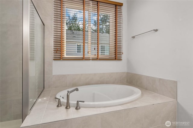 full bathroom with a bath and tiled shower