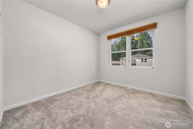 unfurnished room featuring carpet flooring, baseboards, and visible vents