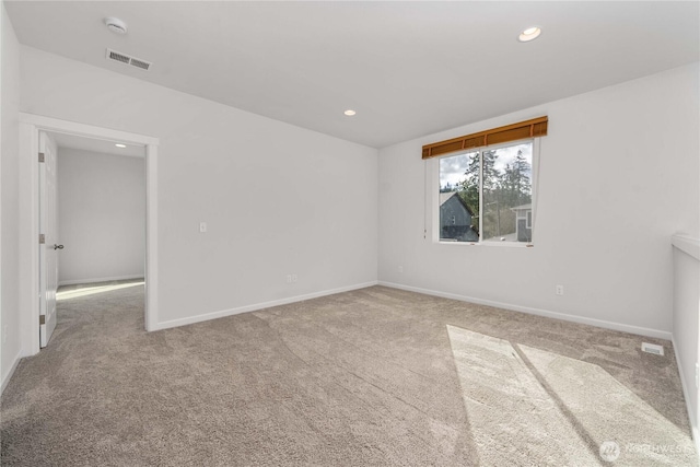 carpeted spare room featuring visible vents, recessed lighting, and baseboards