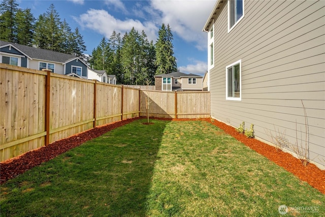 view of yard featuring a residential view and a fenced backyard