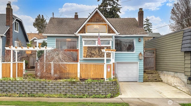 view of front of property featuring fence, concrete driveway, a shingled roof, a garage, and a chimney