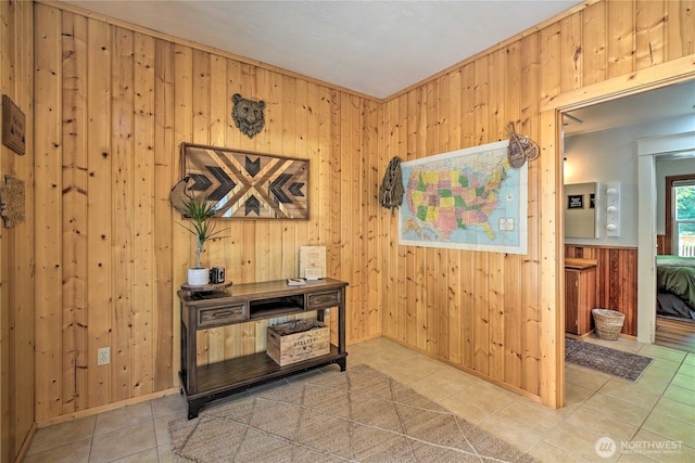 office space with wooden walls and light tile patterned flooring