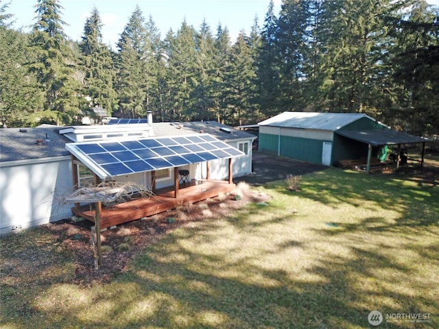 exterior space featuring a forest view and an outdoor structure