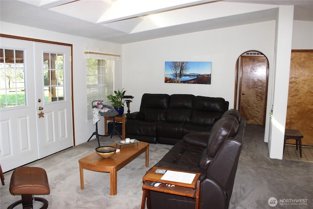 living room featuring vaulted ceiling and carpet