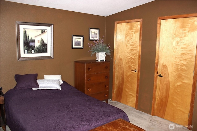 carpeted bedroom with vaulted ceiling