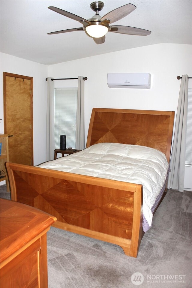 carpeted bedroom featuring ceiling fan and a wall mounted AC