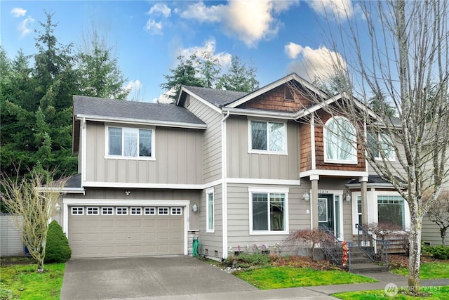 view of front of home featuring a garage, roof with shingles, board and batten siding, and concrete driveway