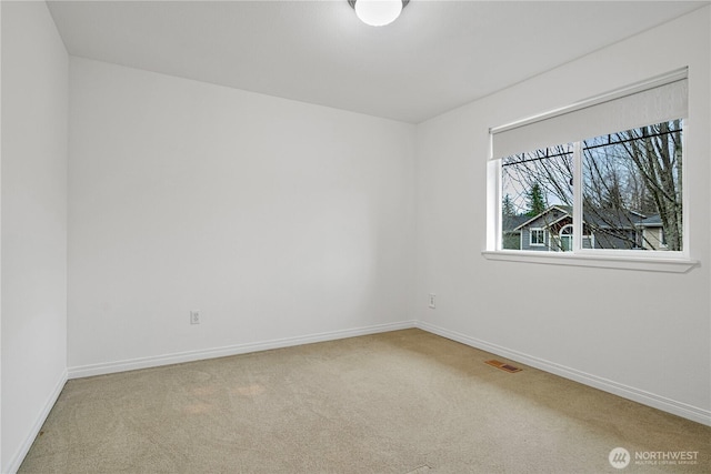 unfurnished room featuring visible vents, baseboards, and carpet flooring