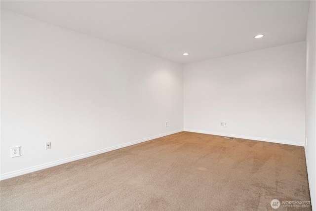 spare room with recessed lighting, baseboards, and carpet