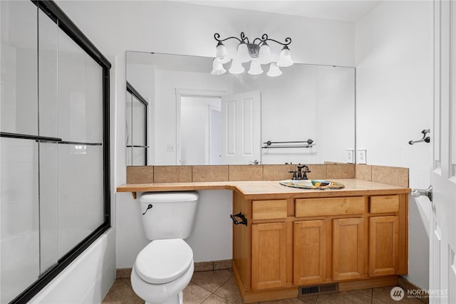 bathroom with vanity, visible vents, enclosed tub / shower combo, tile patterned flooring, and toilet