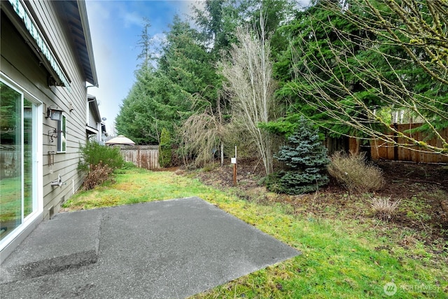 view of yard with a patio and fence