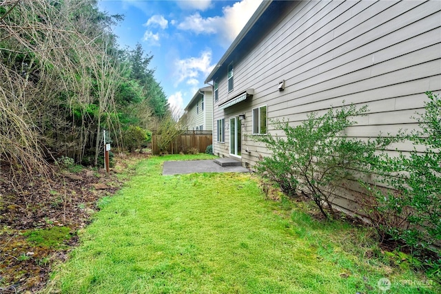 view of yard featuring a patio and fence