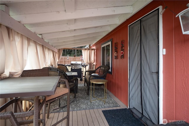 deck with outdoor dining space and fence