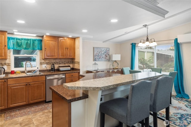 kitchen featuring a kitchen bar, a notable chandelier, a sink, backsplash, and dishwasher