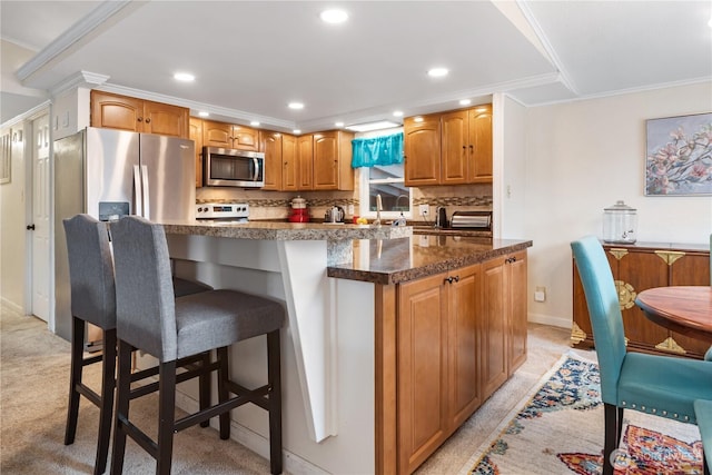 kitchen with tasteful backsplash, a kitchen bar, ornamental molding, recessed lighting, and stainless steel appliances