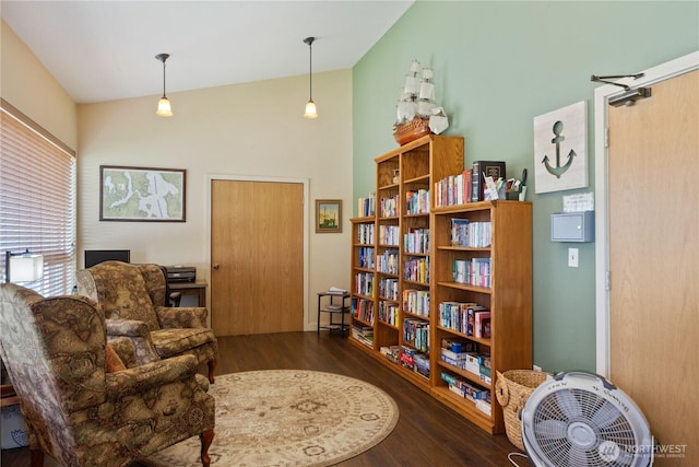 living area with lofted ceiling and wood finished floors