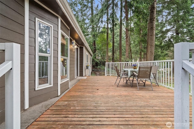 wooden terrace with outdoor dining space