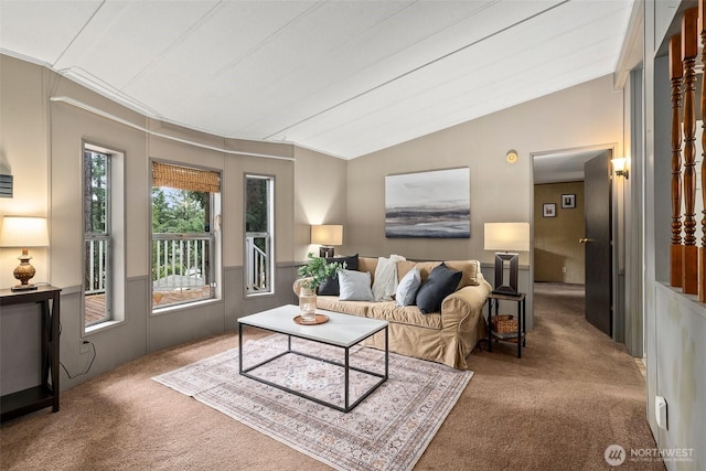 living room with lofted ceiling and carpet floors